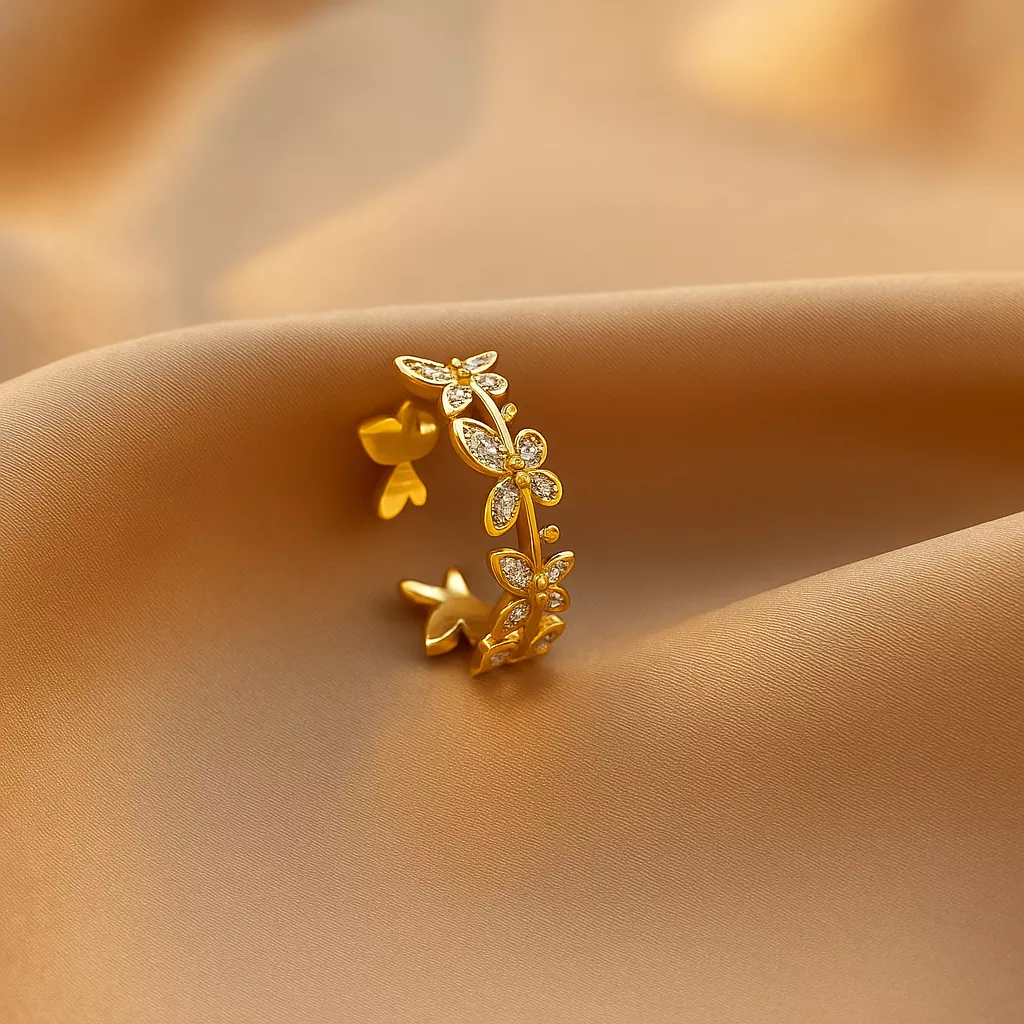 Gold butterfly stainless steel ring with zircon stones on satin background – elegant and adjustable jewelry design for women