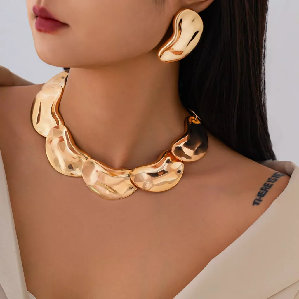 Gold stainless steel statement necklace and matching earrings set with sculptural design, wholesale jewelry by Yanluo Jewelry