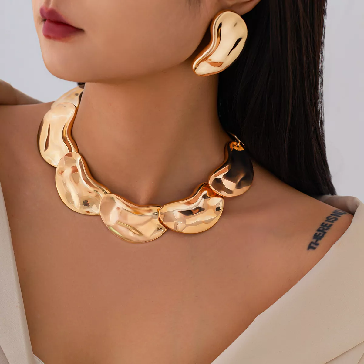 Gold stainless steel statement necklace and matching earrings set with sculptural design, wholesale jewelry by Yanluo Jewelry