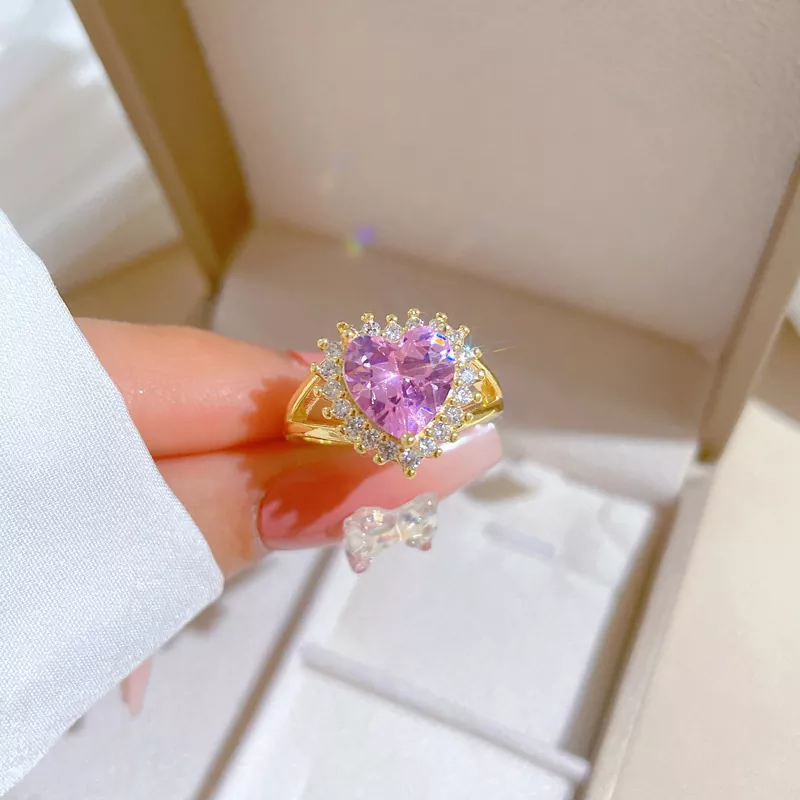 Gold stainless steel ring with pink heart-shaped stone and zirconia halo, wholesale jewelry by Yanluo Jewelry.