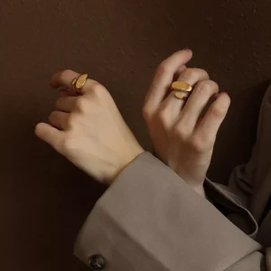 Minimalist gold stainless steel rings worn on hand, modern open-band design, wholesale jewelry collection by Yanluo Jewelry