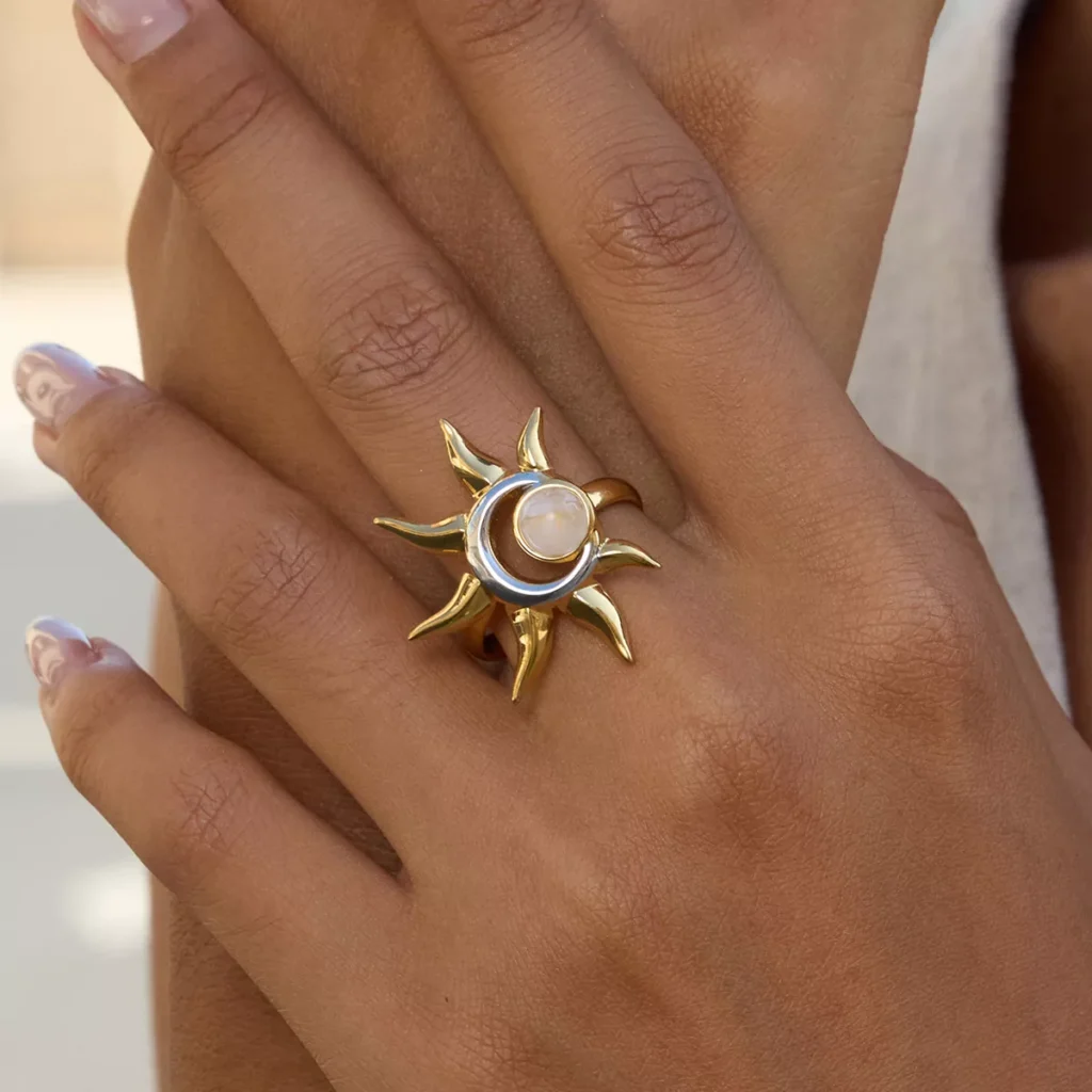 Gold stainless steel ring with sun and moon design, featuring a luminous stone centerpiece, wholesale jewelry by Yanluo Jewelry