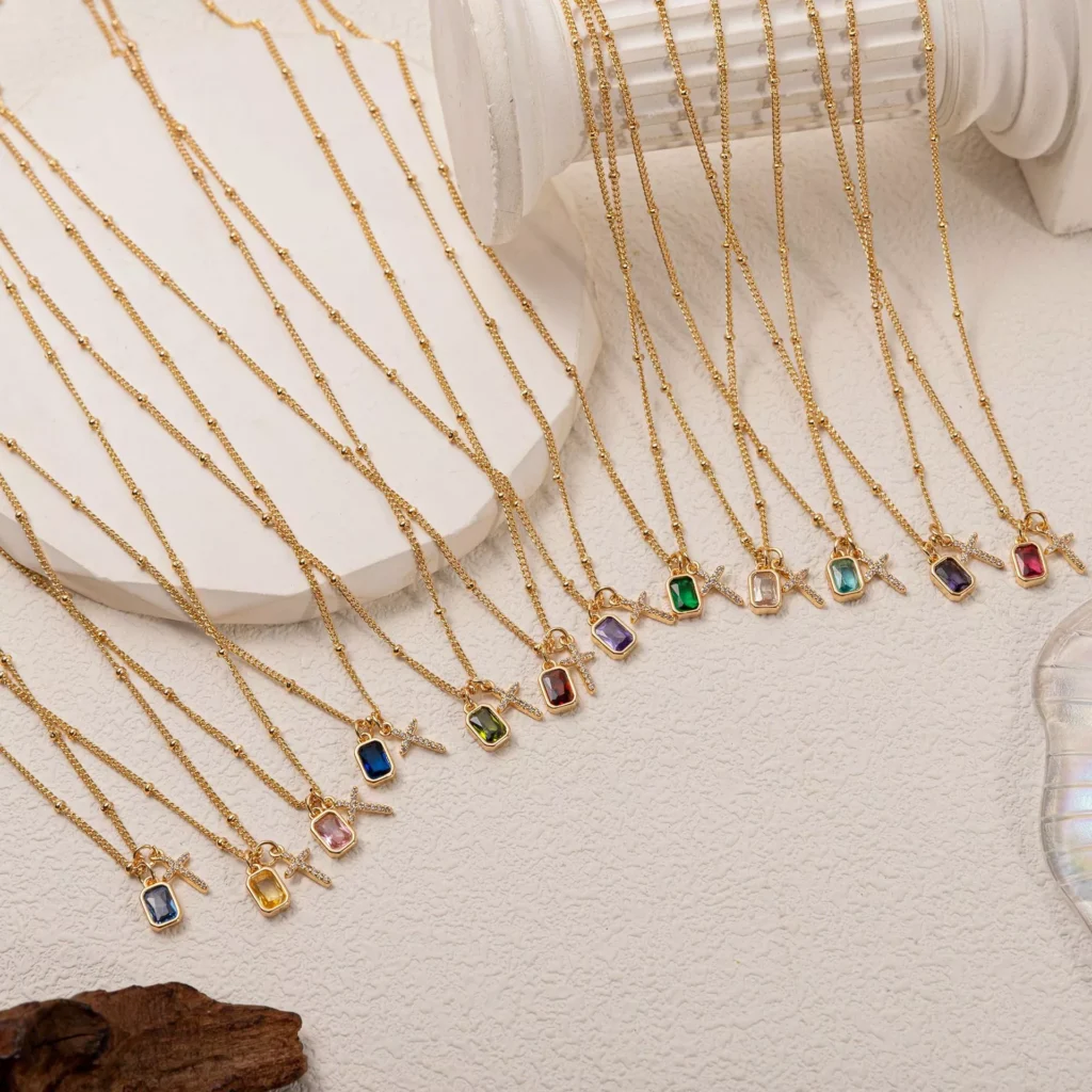 Multi-color crystal pendant stainless steel necklaces on gold chains displayed by Yanluo Jewelry, stainless steel jewelry wholesale supplier.
