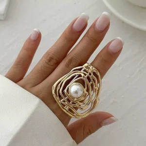 The gold stainless steel ring features a unique hollow spiral shape with a round white imitation pearl inlaid in the center, which looks elegant and modern when worn on the wrist.