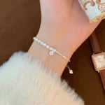 Elegant stainless steel charm bracelet with pearls and crystal pendant for wholesale buyers