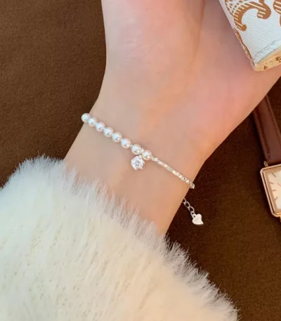 Elegant stainless steel charm bracelet with pearls and crystal pendant for wholesale buyers